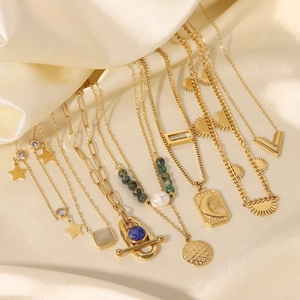 Gold-plated stainless steel necklaces with pearls and celestial pendants on satin