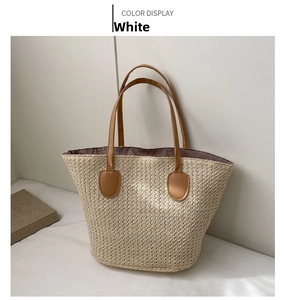 Close-up of woven straw texture and premium brown leather handle on a stylish beach bucket bag