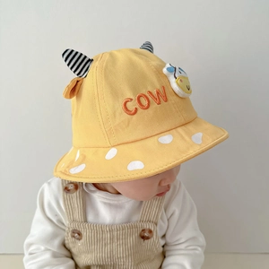 Detail of yellow baby bucket hat with COW embroidery and cute cartoon 3D cow patch
