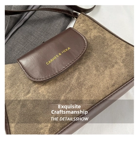 Detail of vintage denim and brown leather shoulder bag with logo branding