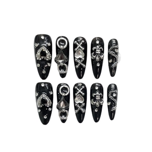 Gothic black press-on nails with silver heart and cross charms in stiletto shape