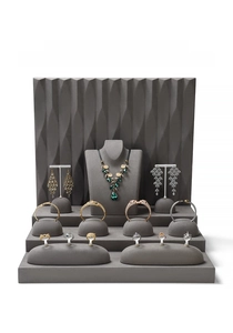 Macro display of luxury jewelry set with panther motifs on tiered stone display stands