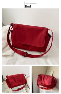 Detailed views of red oxford fabric messenger bag with side pocket and adjustable strap