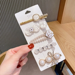Detail of five-piece hair clip set featuring pearls, rhinestones and marble resin