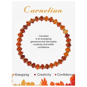 Flat lay of red carnelian beaded bracelet on a white healing crystal card with gold spacers