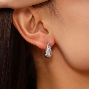 U-shaped stainless steel earrings with pavé set cubic zirconia on earlobe