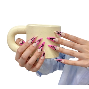 Pink and nude stiletto press-on nails with black corset style hand-painted design