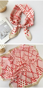 Detailed view of a red polka dot silk scarf with elegant geometric lines and satin finish