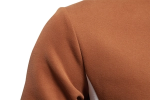 Close-up of the shoulder stitching and fine texture on a brown crewneck sweatshirt