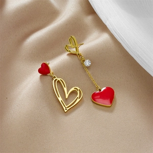 Asymmetric gold and red heart drop earrings with sparkling rhinestones on silk