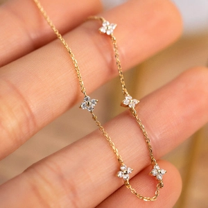 Elegant S925 sterling silver four-leaf clover bracelet with gold finish and zircon stones