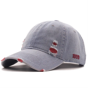 Distressed light blue denim baseball cap with red 1999 embroidery and torn brim details