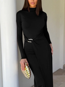 Detail of waist twist knot design with metallic buckle on black slim-fit dress
