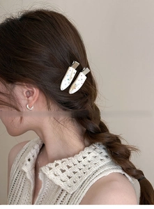 Detail of elegant water drop hair clips with colorful rhinestones on female model