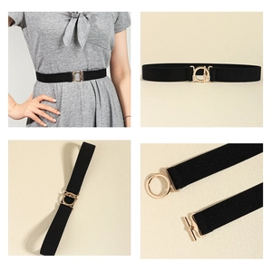 Detail of black elastic skinny belt featuring a golden metal round T-buckle closure