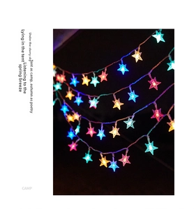 Close-up of colorful star-shaped LED fairy lights for outdoor camping and tent decor