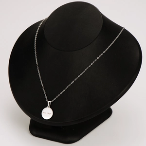 Silver stainless steel necklace with engraved Merry and Bright pendant on a black bust