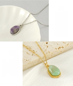 Detail of lead-free stainless steel necklaces with purple and green natural stone pendants