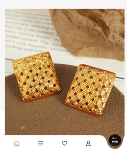 Macro detail of square woven gold earrings featuring intricate metallic textures