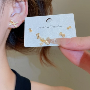 Detailed view of 18k gold plated bowknot earrings set with sparkling cubic zirconia stones