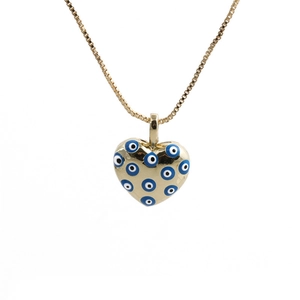 Detail of gold heart pendant with blue evil eye patterns on a sleek box chain