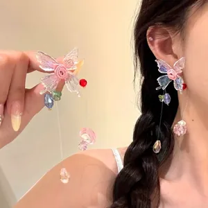 Detail of butterfly drop earrings with aurora wings and multi-color crystal beads