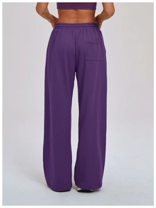 Detail view of the high-elastic waistband and back pocket of deep purple sports pants