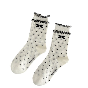 Sweet white crew socks with black polka dots and a delicate bow tie on the cuff