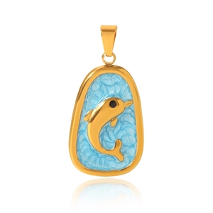Macro shot of gold dolphin pendant with blue enamel inlay and textured metal details
