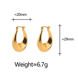 Detailed view of gold C-shaped chunky earrings with 29mm height and 20mm width