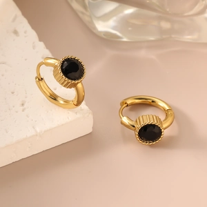 Polished 18K gold-plated stainless steel earrings with black zircon stones on a pedestal