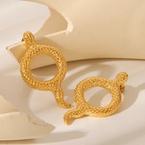 Detail of 18K gold snake hoop earrings featuring intricate scales and a polished finish