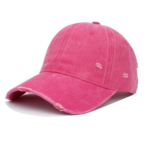 Detail of distressed pink baseball cap showing washed texture and vintage ripped holes