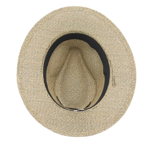 Straw fedora hat with black belt and hollow weave texture shown from a top-down view