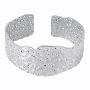 Detail of silver stainless steel cuff bracelet featuring a hammered vintage texture