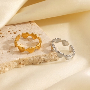 Polished 18K gold and silver plated heart chain open rings on natural stone background