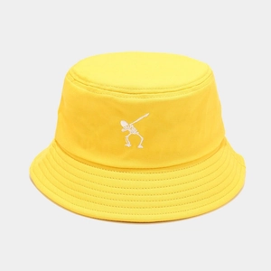 Close-up of white skeleton embroidery on a bright yellow cotton punk bucket hat