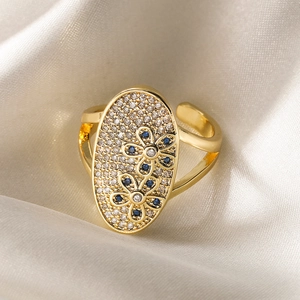 Gold-plated adjustable ring with blue flower zircon oval surface on silk background