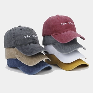 Macro detail of multi-color washed cotton baseball caps with Stay Wild embroidery