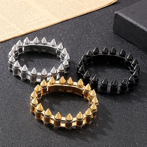 Detailed close-up of bullet rivet steel bracelets in gold, silver and black finishes