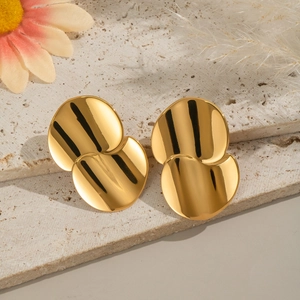 Minimalist geometric circular earrings in 18K gold finish on a textured slate background