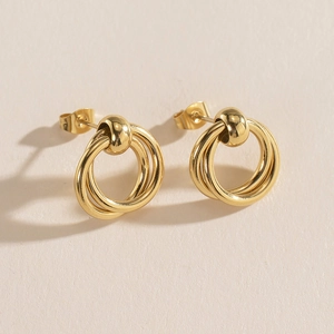 Macro shot of 14K gold-plated stainless steel earrings with triple interlocking rings