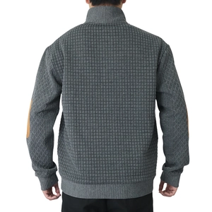 Detail of dark grey quilted jacket with stand collar and orange elbow patch on the sleeve