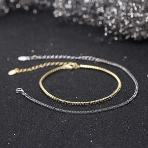 Close-up of adjustable 1.5mm tennis bracelets with white and black zircon in gold and silver