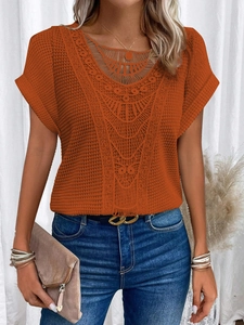 Short sleeve knit top in vibrant orange featuring delicate lace v-neckline and crochet texture