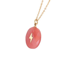 Golden necklace with faceted pink stone pendant featuring a gold lightning bolt symbol