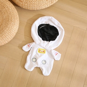Cute white astronaut plush suit for kids with embroidery details on a wooden background