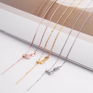 Macro detail of adjustable S925 silver necklace chains in gold, rose gold and silver