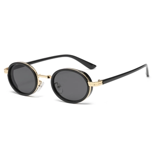 Oval retro sunglasses with black frames and gold metal bridge in a 45-degree angle view