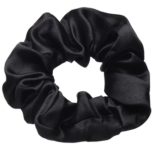 Close-up of black satin scrunchie showing glossy silk texture and pleated elastic band